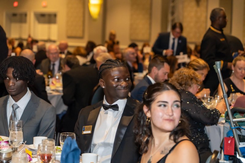 TreVaughn Ellis shares a table with his younger brother RenAaron Ellis, left, and other attendees at the NOGI Awards banquet.